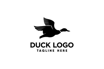 Fototapeta na wymiar vector logo of a duck in flight in silhouette style