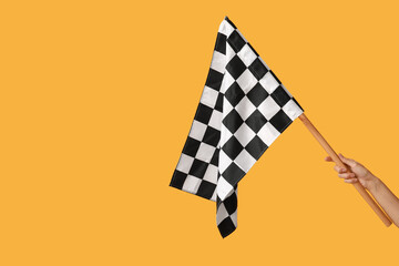Woman with racing flag on yellow background