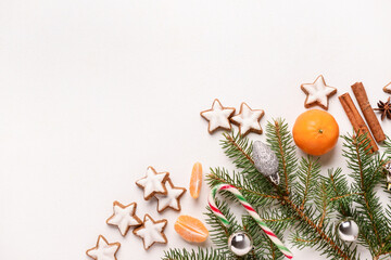 Composition with delicious stars shaped Christmas cookies, mandarins and fir tree branches on light...