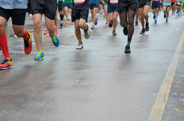 Marathon running race, many runners feet on road racing, sport competition, fitness and healthy...