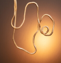 Gold chain in a beautiful gold background