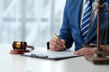 Consultant or lawyer and scales, hammer of justice read contract details before signing to check...