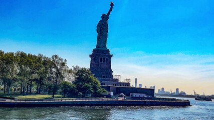 The lady of New York (USA) seen from behind and a boat, is how the statue of liberty of the Big...
