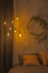 New Year's wreath over bed with bright lamps shining warm cozy light