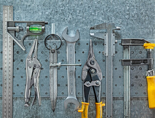 Construction Tools Composed On Metalic Plate And Background Of Metall Sheet.