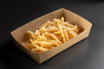 Delicious, tasty french fries topping with Parmesan cheese. Deep fry potato or appetizer, fast food. Dish of crisp golden potato chips.
