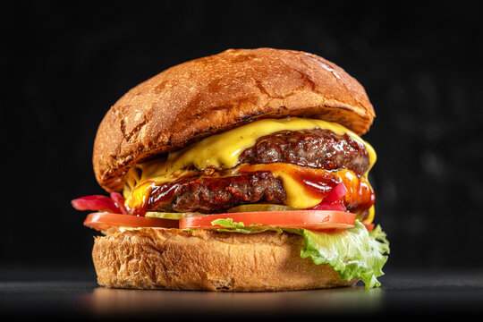 Delicious double cheeseburger close up on a black background. Delicious cheeseburger. sandwich fast food, amazing food