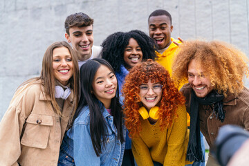 Vibrant multiethnic group of friends posing for a photographer outdoors, exuding joy and friendship...
