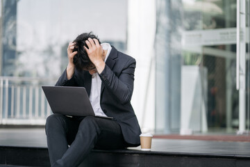 Concept of business failure and unemployment problem, unemployment stress businessman sitting on stairs.