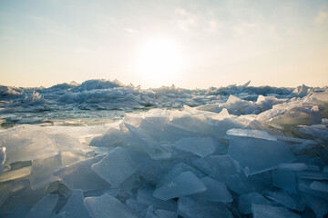 Large pieces of ice near the river bank at sunset - Powered by Adobe