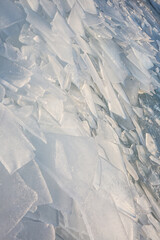 Large pieces of ice near the river bank at sunset