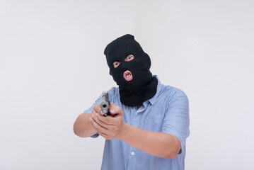 A scary and unhinged evil robber pointing a gun threatening to shoot. Commanding at gunpoint....