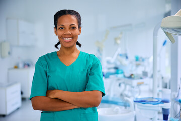 Confident black female dentist at dental clinic looking at camera.