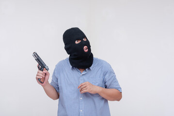 A deranged middle aged man in a black mask. A wary robber looking around while holding a gun....