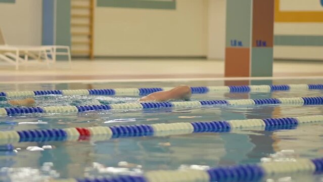 Man swimming in a Swimming Pool. Athlete, Sports, Swimming Training, Lane Lines
