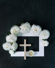 christiany cross, flowers and candle on abstract black background. concept of faith, Christianity,...