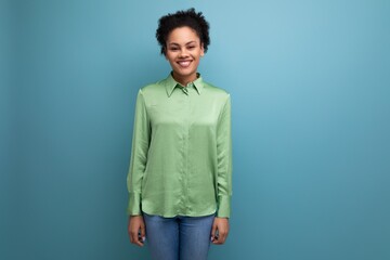 young confident latin business lady in green blouse on studio background with copy space