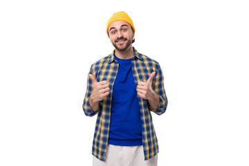Fototapeta premium cute charming young hipster man in yellow cap and shirt on white background with copy space