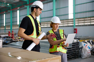 workers or engineers working on laptop computer in the factory