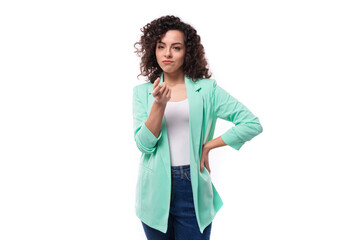young pretty curly brunette employee of a business company woman dressed in an office blue jacket