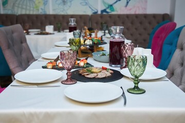 The setting of the festive table. Food and dishes.