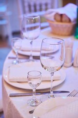 The setting of the festive table. Food and dishes. Festive glasses for drinks.