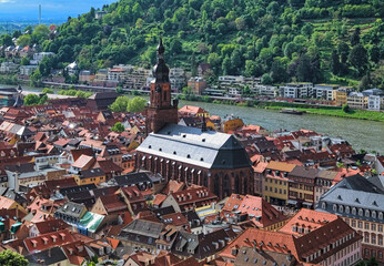 Church of the Holy Spirit in Heidelberg Old Town, Germany. View from the lower slope of Konigstuhl hill. The church was constructed between 1398 and 1515. - 697628243