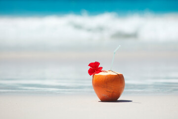 Tropical fresh coconut cocktail on white beach. Holiday and vacation concept. Tropical beach.