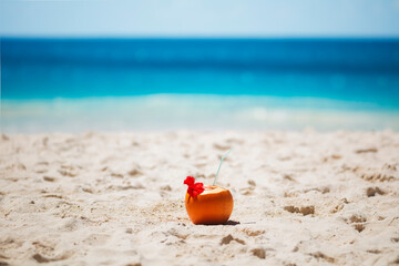 Tropical fresh coconut cocktail on white beach. Holiday and vacation concept. Tropical beach.