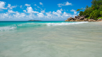 Fototapeta premium Palm and tropical beach panorama. Anse Lazio beach at Praslin island, Seychelles, long exposure, vintage toning