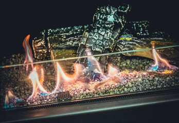 Modern bio fireplot fireplace on ethanol gas. Smart ecological alternative technologies. Contemporary biofuel on ethanol close-up. Energy saving innovation. Interior inside house. Decorated fireplace.