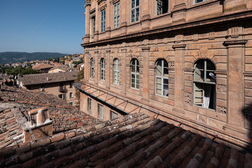 Fototapeta premium Medieval Italian town with brick houses and tiled roofs and distant hills at sunny day, Perugia, Italy