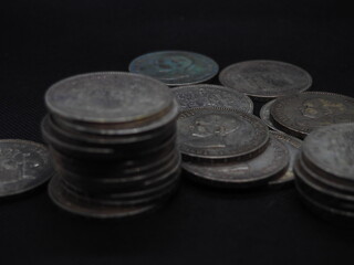 Five peseta coins, silver coins of Alfonso XIII on a black background