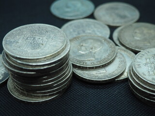 Five peseta coins, silver coins of Alfonso XIII on a black background