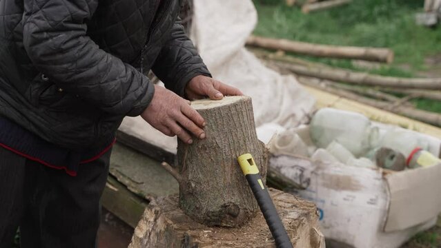 A man is preparing to chop firewood