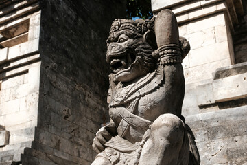 Demon at the entrance to the temple. Decoration of Uluwatu hindu Temple. Bali, Indonesia.
