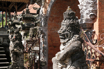 Demons by the gate of Ubud Palace on sunny day. Ubud, Bali, Indonesia.