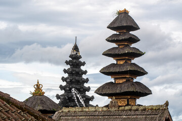 Towers of Besakih Great temple on cloudy day. Bali, Indonesia.