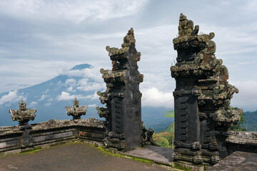View of Pura Lempuyang Madya hindu temple and Mount Agung on cloudy day. Bali, Indonesia.