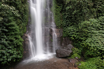 View of Golden Valley waterfall on cloudy day. Munduk, Bali, Indonesia.