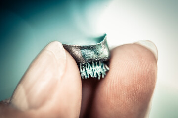 Small object printed on metal 3d printer macro. Dental crowns created in laser sintering machine...