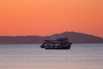 A passenger boat and a sunset