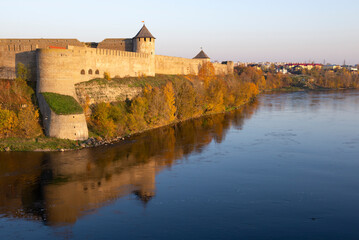 Ivangorod fortress above the border river Narva on a sunny October evening. Leningrad region, border of Russia and Estonia