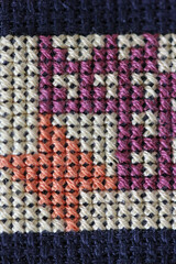 Mixed colour cross stitch embroidery in close up