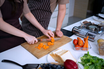 Young couple is cooking in kitchen.