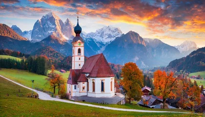 Zelfklevend Fotobehang iconic picture of bavaria with maria gern church with hochkalter peak on background fantastic autumn sunrise in alps superb evening landscape of germany countryside traveling concept background © Ashley