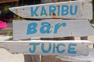 Karibu bar wooden sign at beach Zanzibar island