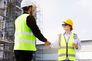 The architect team shake hands and joins in the construction work professionally. Construction business that works with teamwork building construction. Honest cooperation in investing