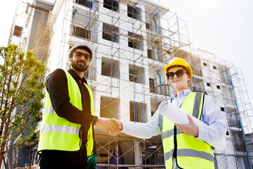 The architect team shake hands and joins in the construction work professionally. Construction business that works with teamwork building construction. Honest cooperation in investing