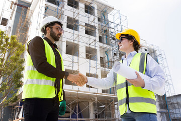 The architect team shake hands and joins in the construction work professionally. Construction business that works with teamwork building construction. Honest cooperation in investing